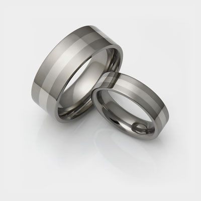 Titanium wedding rings with white gold inlay.